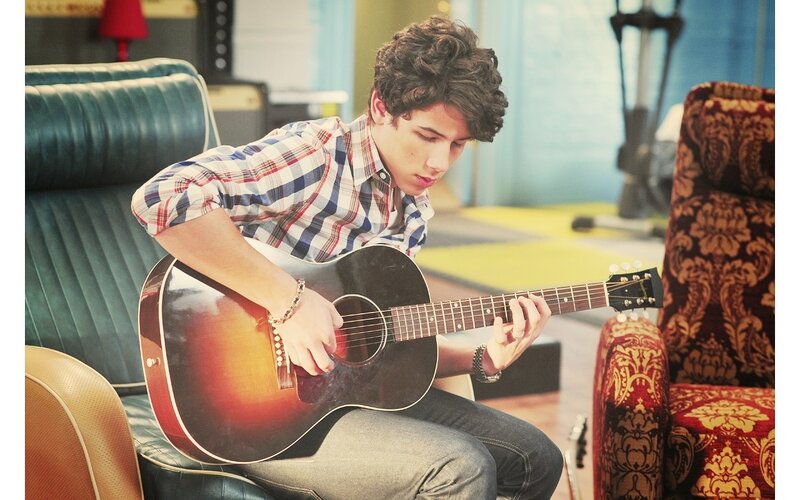 Young man playing acoustic guitar