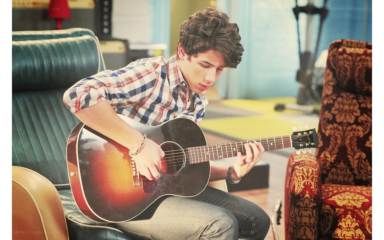 Young man playing acoustic guitar