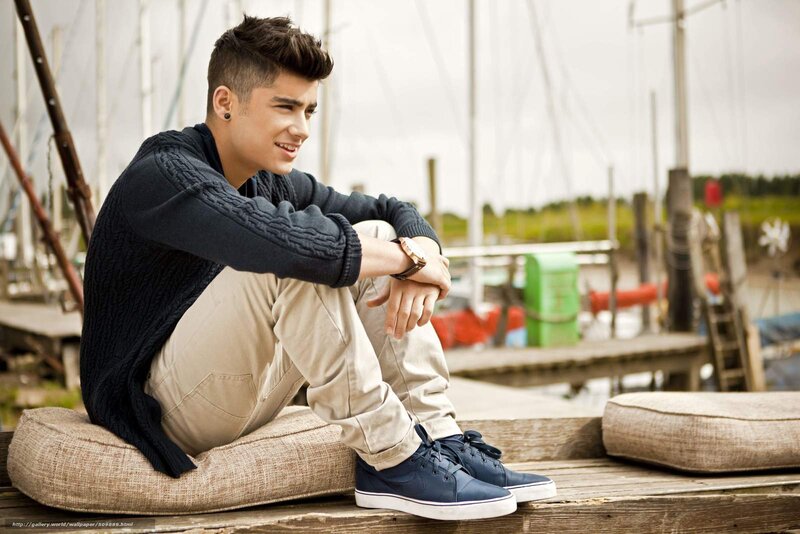 Young Man Sitting on Dock