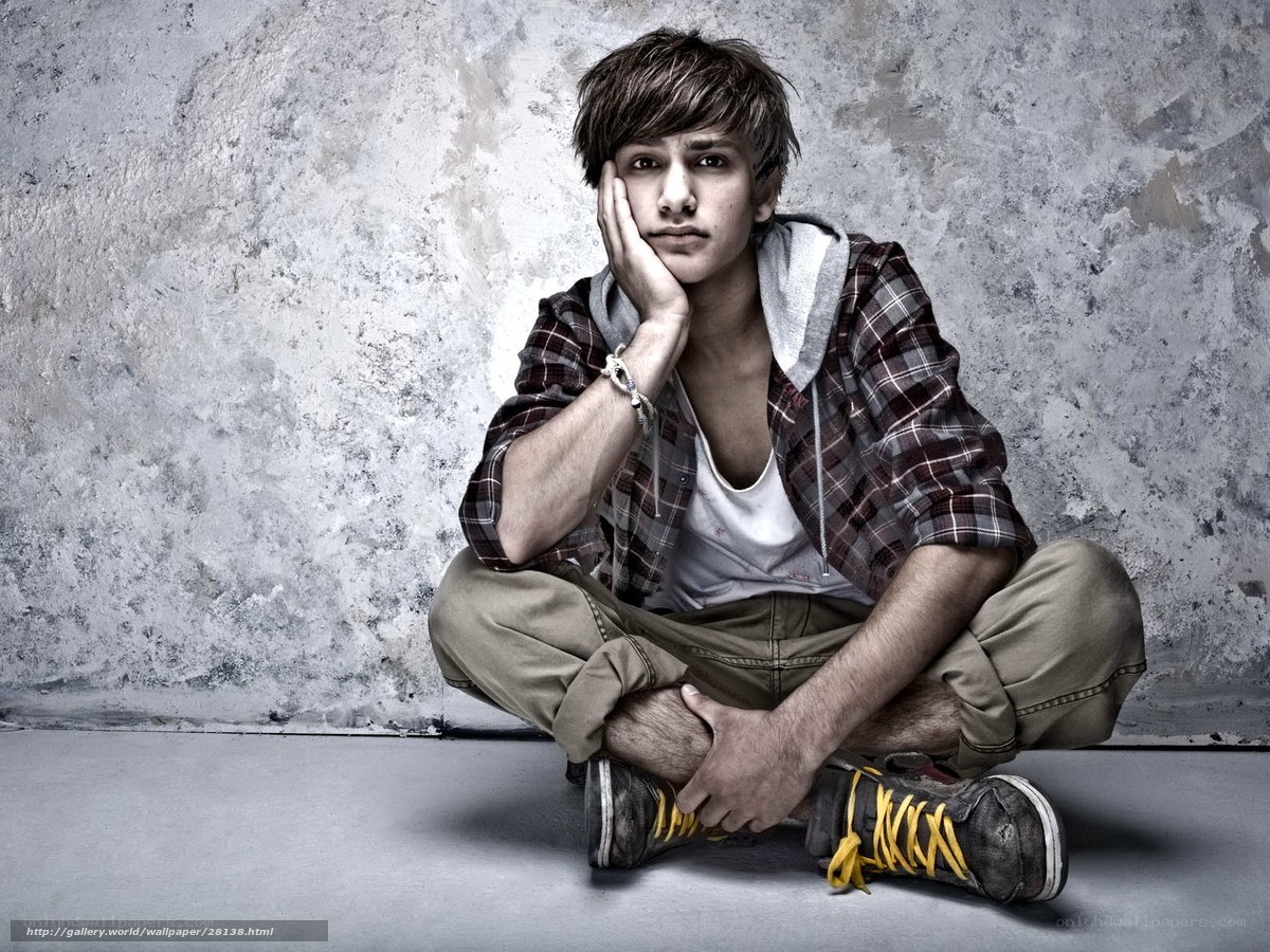 Young man sitting on floor