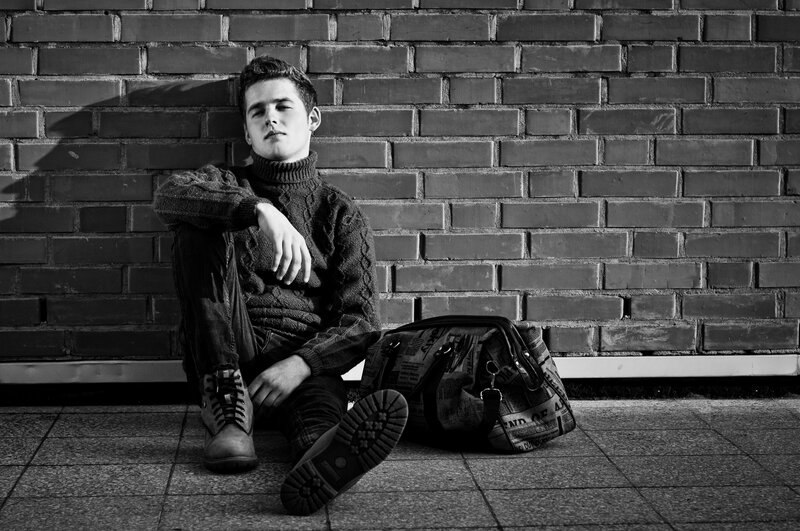 Young Man Sitting on Ground