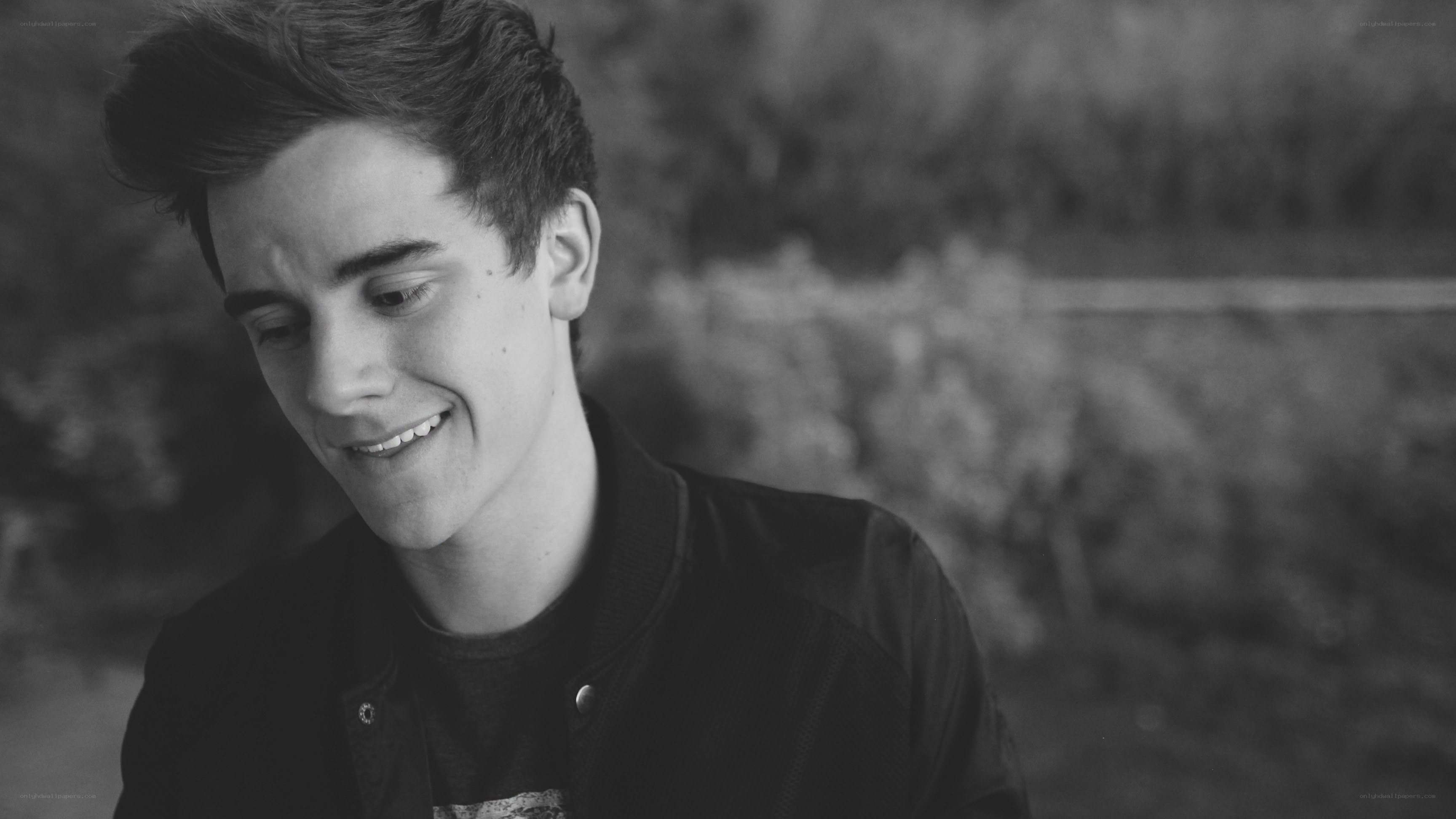 young man smiling outdoors
