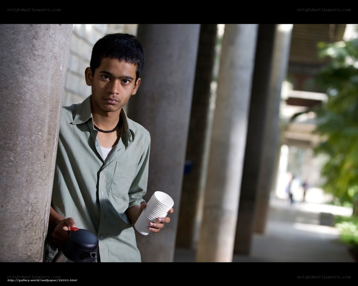 Young man with cups and thermos