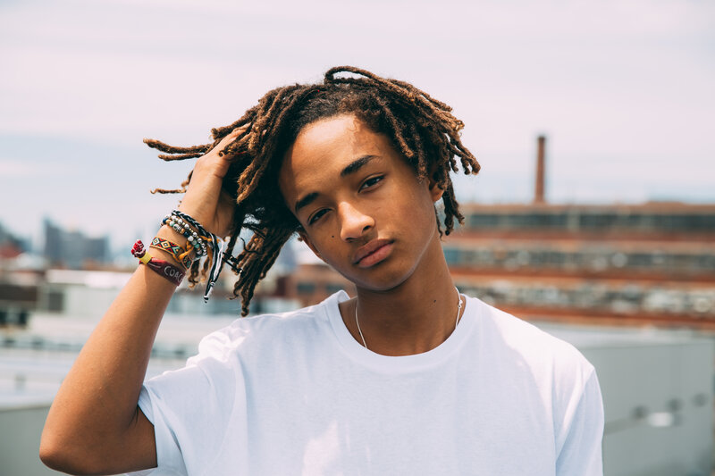young man with dreadlocks on rooftop