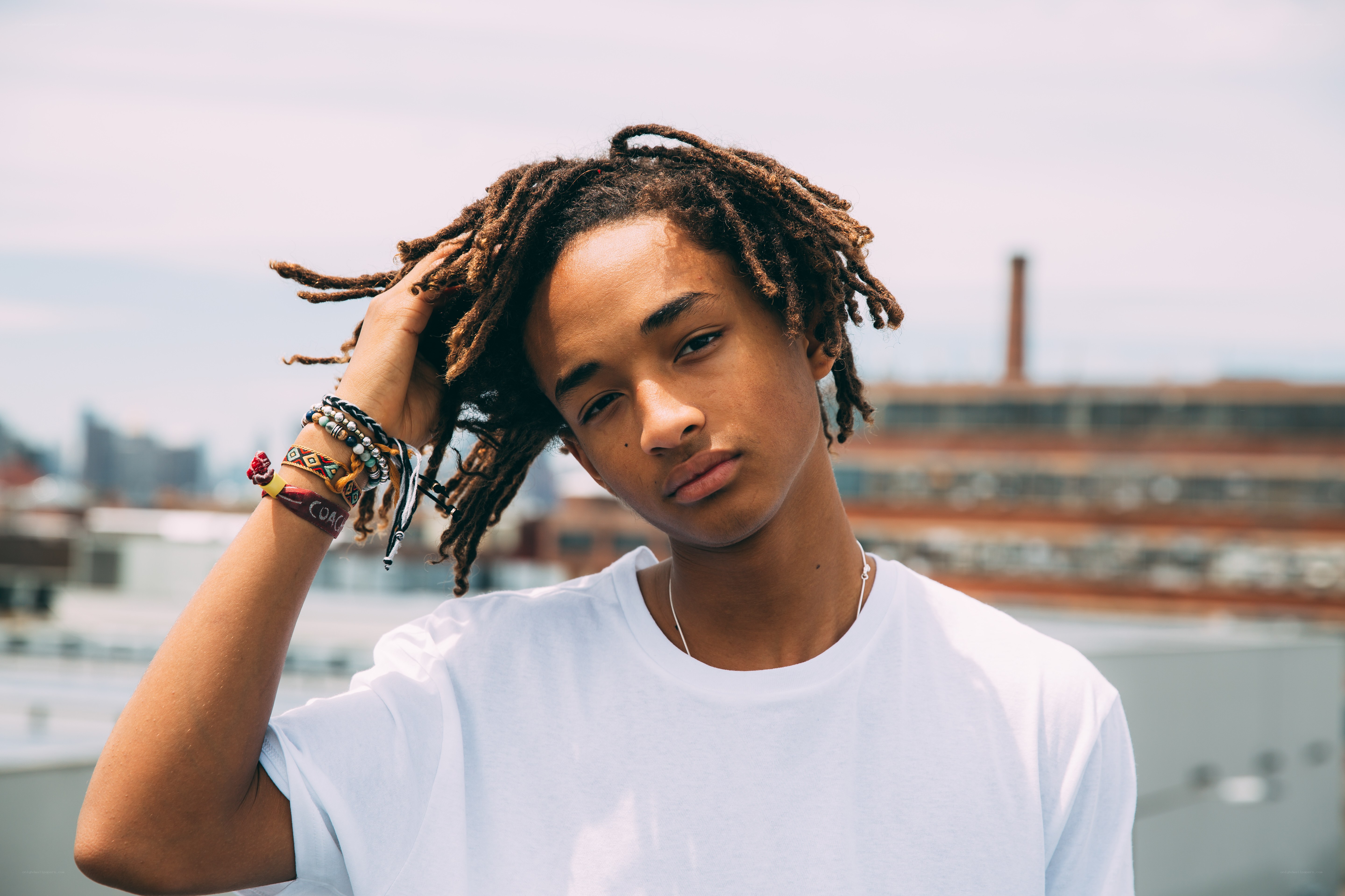 young man with dreadlocks on rooftop