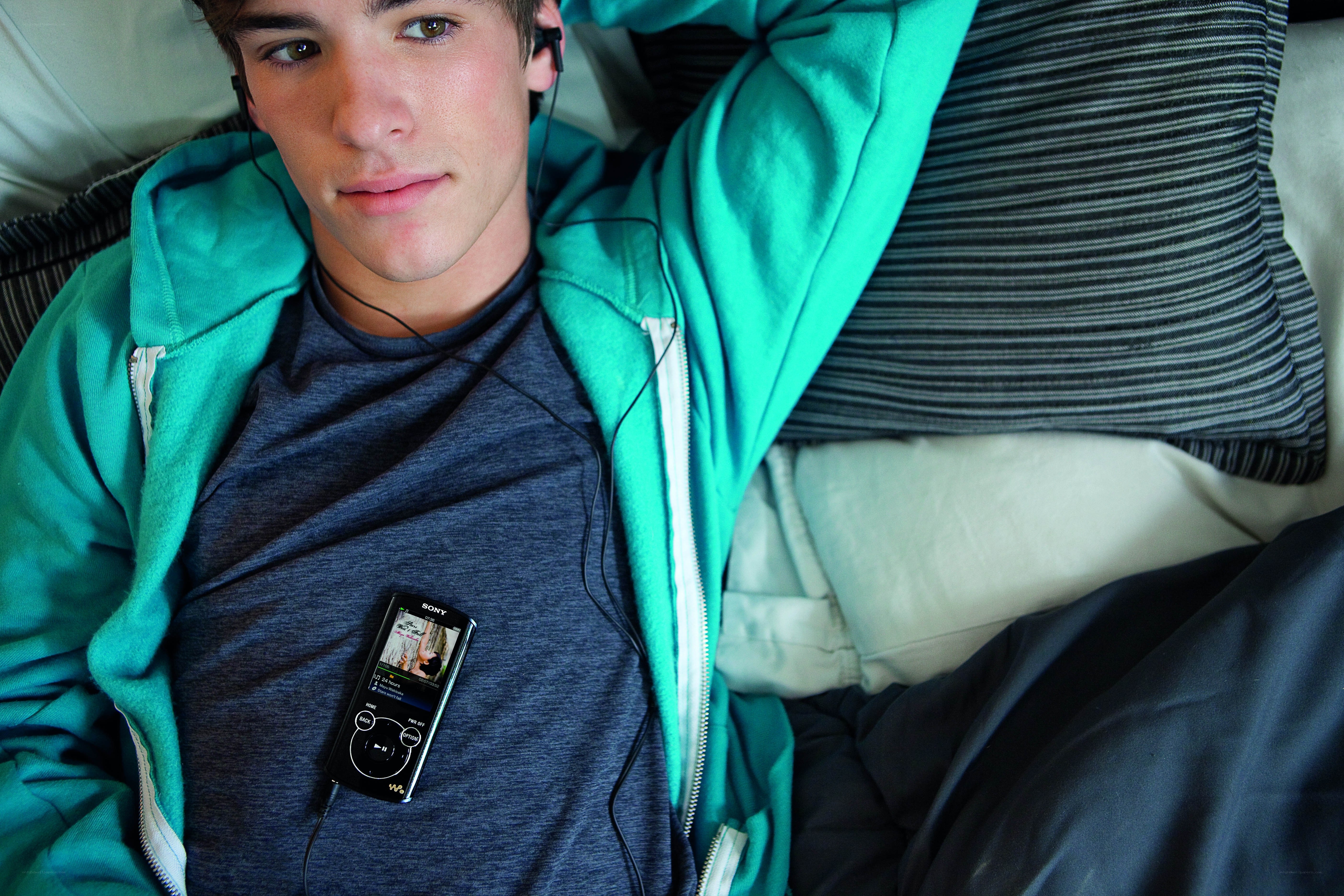 Young man with music player