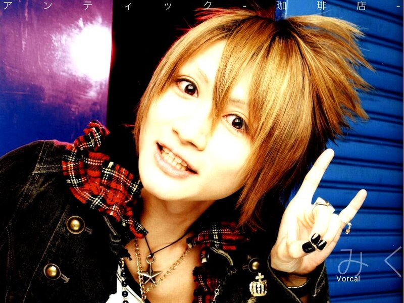 Young man with spiky hair making a hand gesture