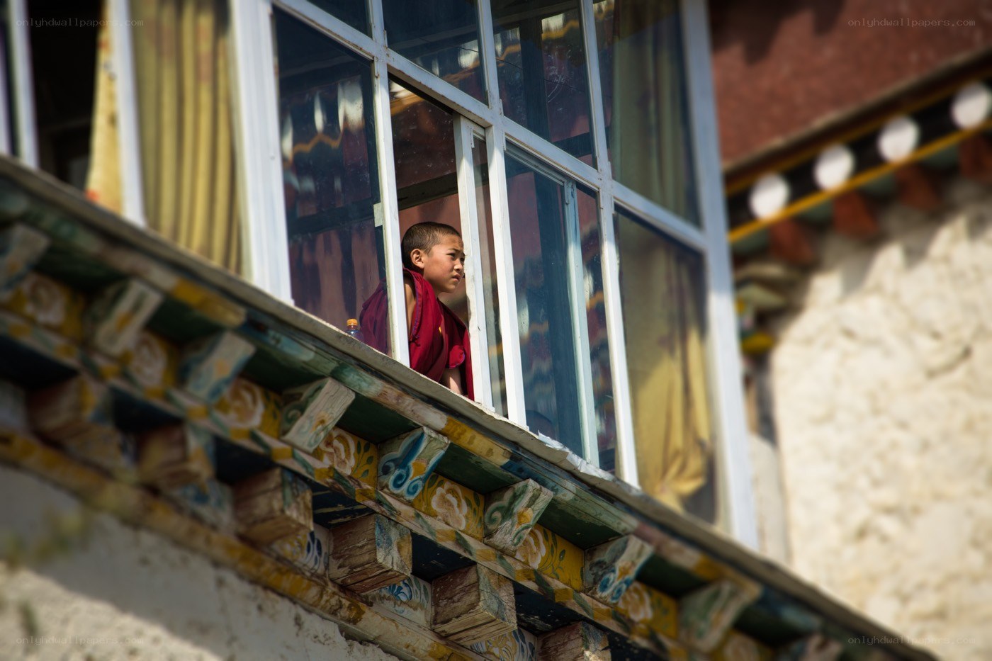 Young monk at window