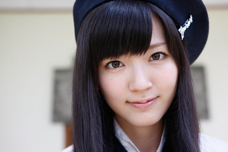 young woman in black hat