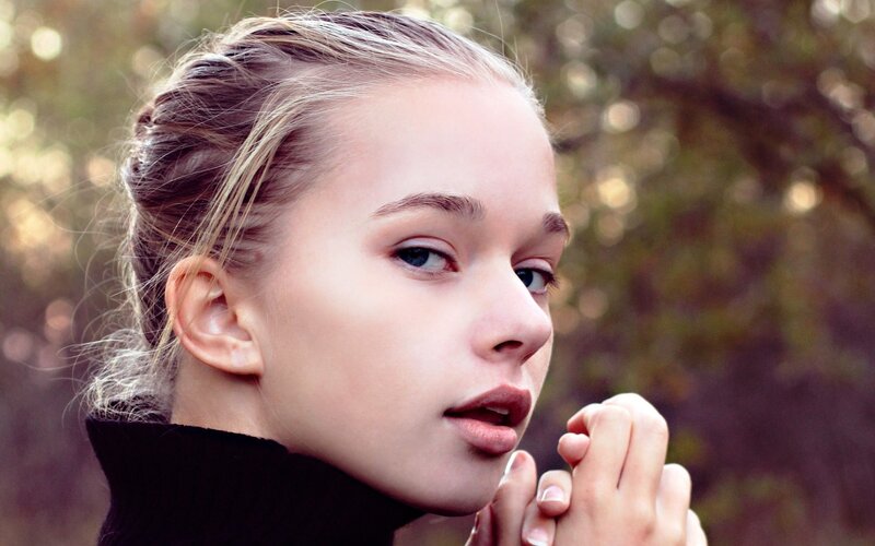 young woman in black turtleneck
