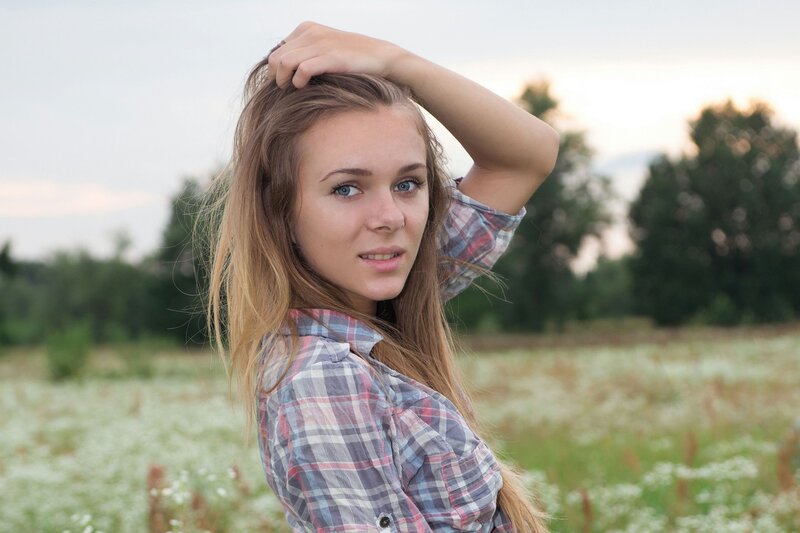 Young Woman in Field — White, Serene, Sunset