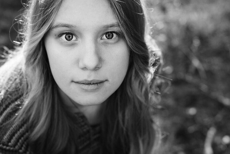 Young Woman in Forest — Black, Serious