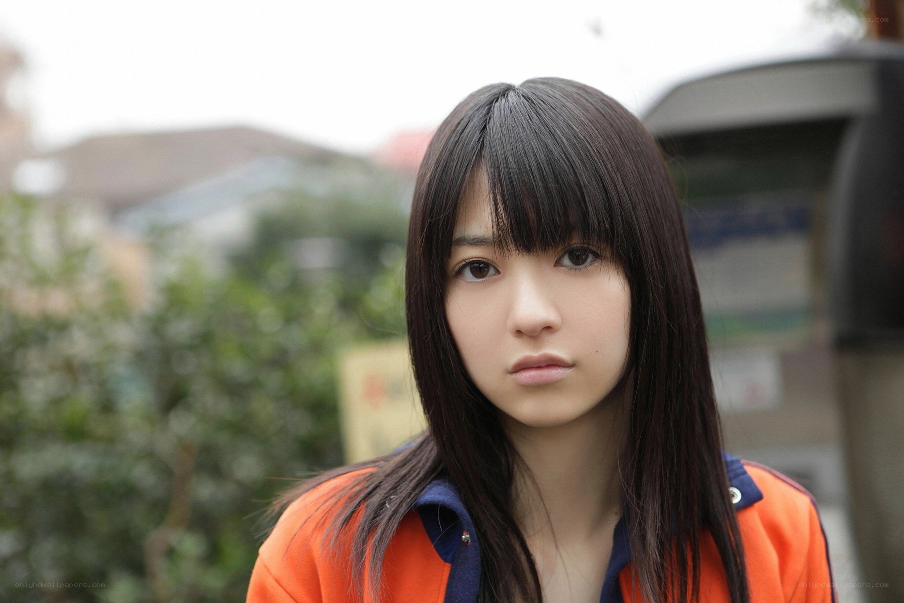 young woman in orange jacket