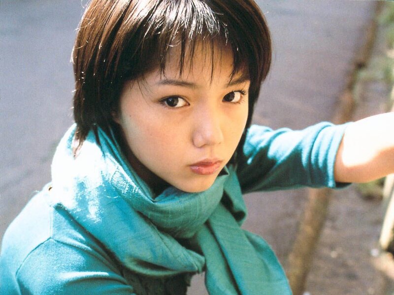 young woman in teal scarf