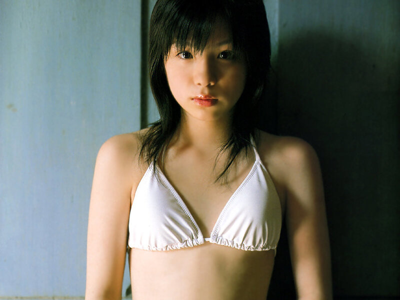 Young woman in white bikini top