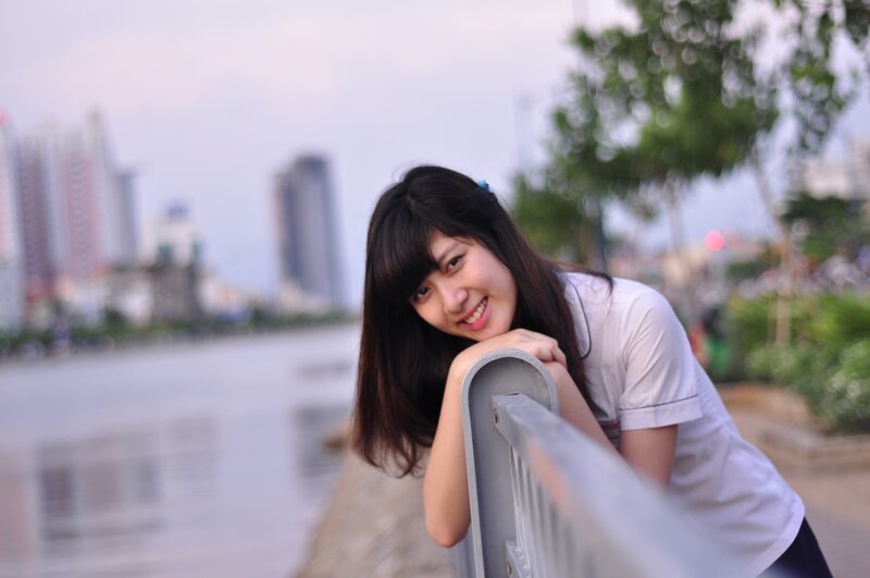 Young Woman Leaning on Railing — White, Calm