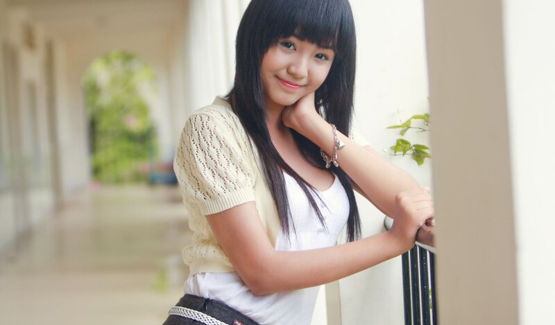 Young Woman Leaning on Railing — White