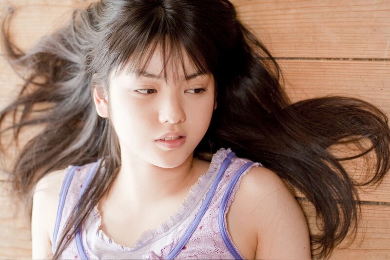 young woman lying on wooden floor