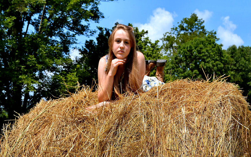 Young Woman on Hay Bale