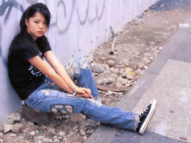 Young Woman Sitting on Ground — Blue