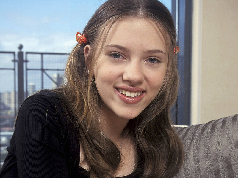 young woman smiling indoors