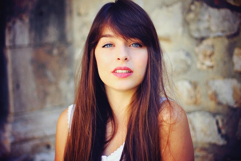 Young Woman with Brown Hair — Calm, Afternoon, Photograph, Stone Wall