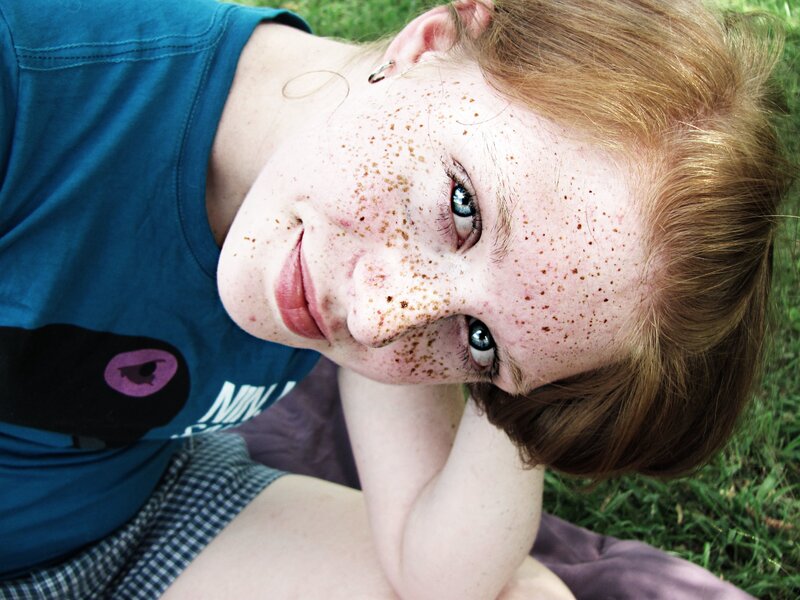 Young woman with freckles smiling