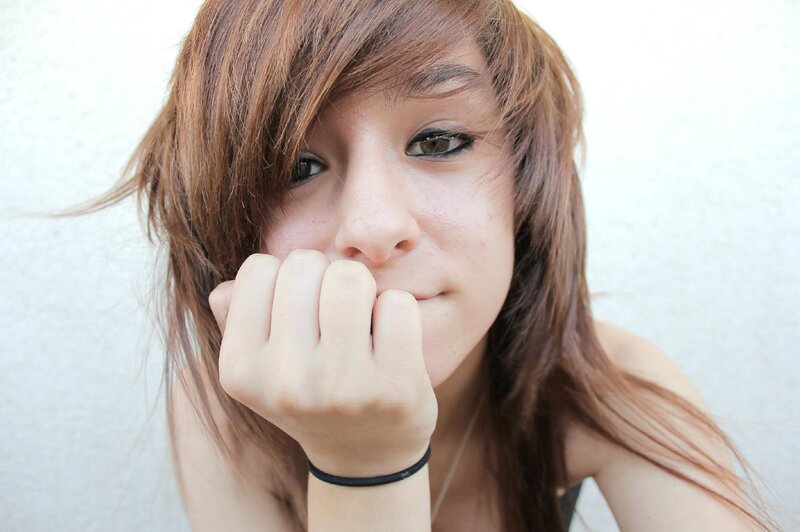 young woman with hand on chin