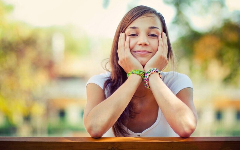 Young Woman with Hands on Face