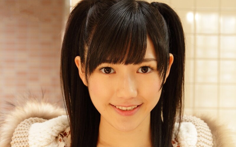young woman with pigtails smiling