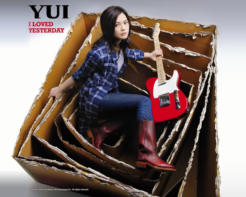 Yui in cardboard box with guitar
