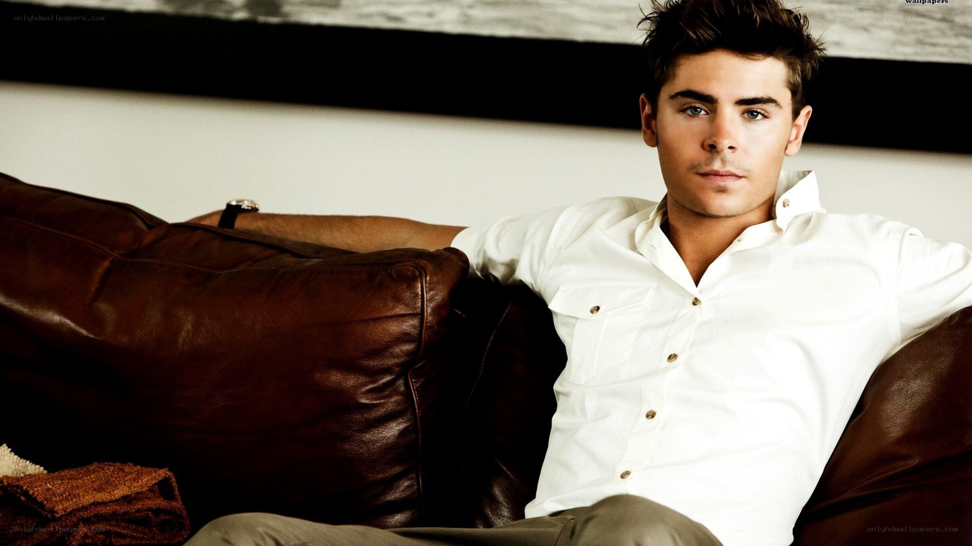 Zac Efron on a leather couch