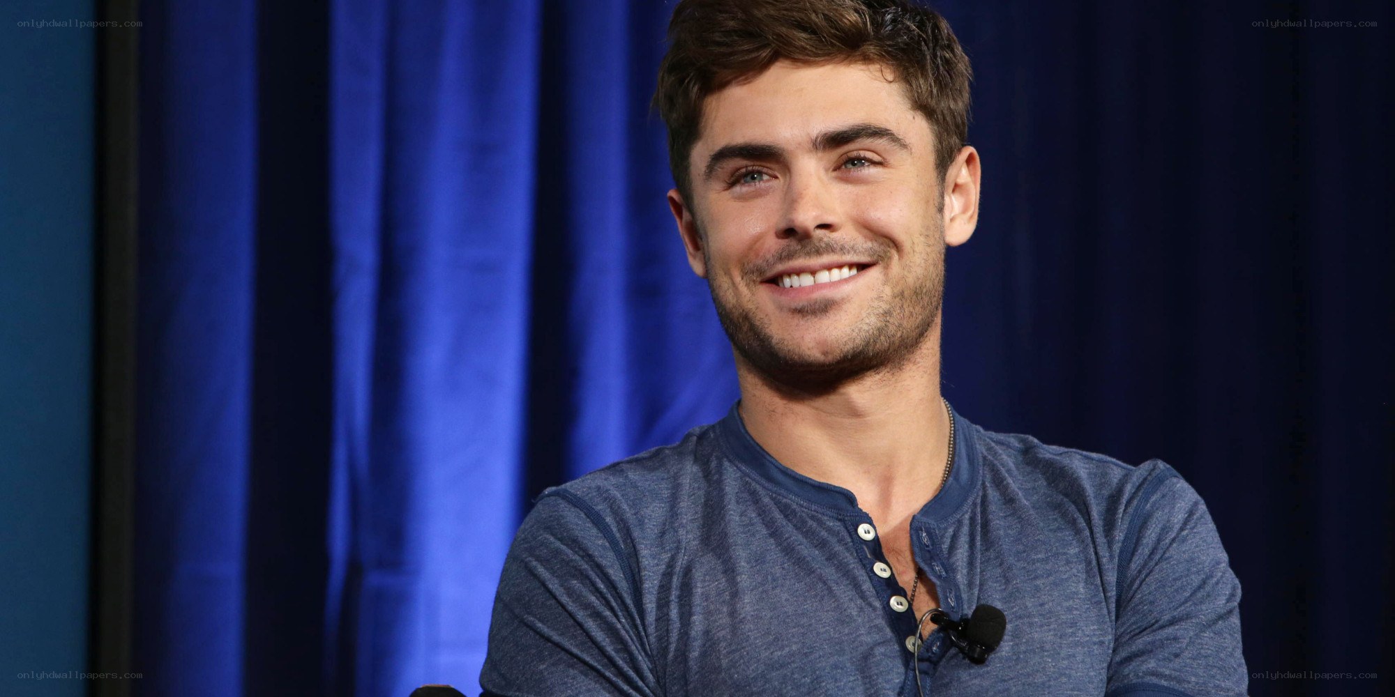 Zac Efron smiling at event