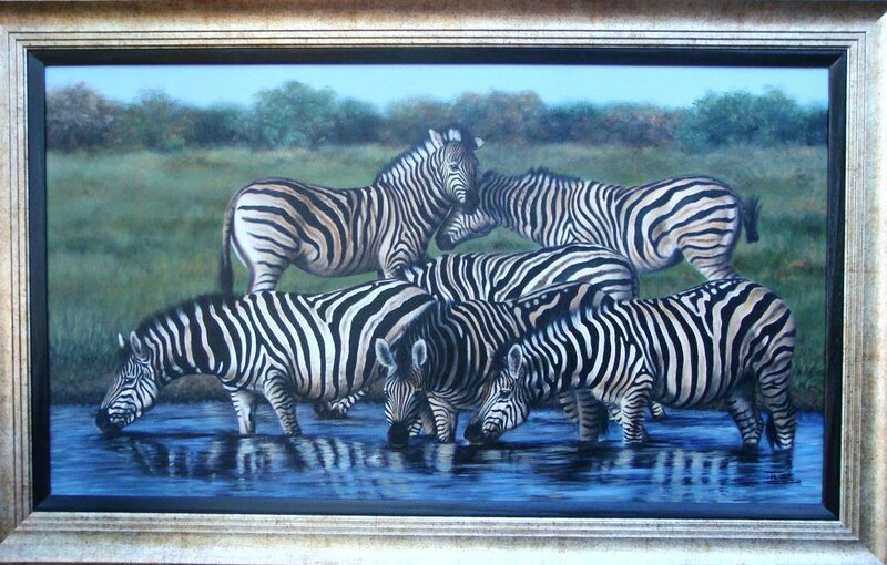Zebras drinking at a waterhole