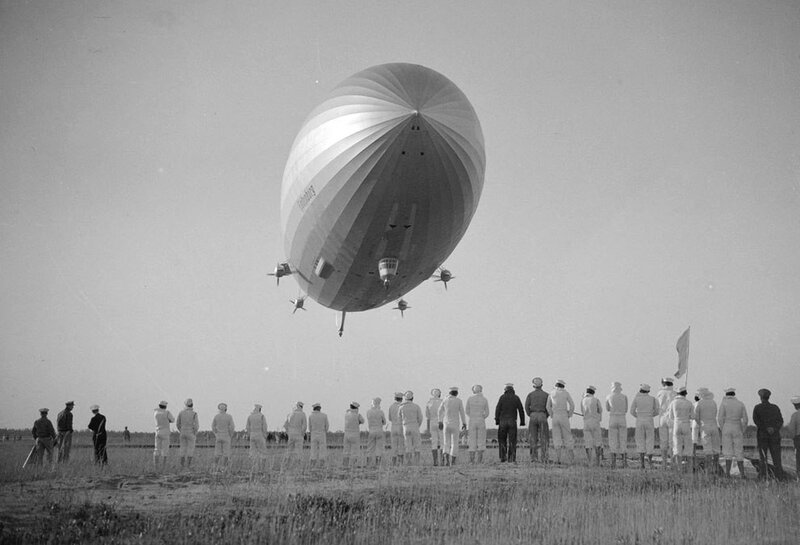 Zeppelin lifting off from field