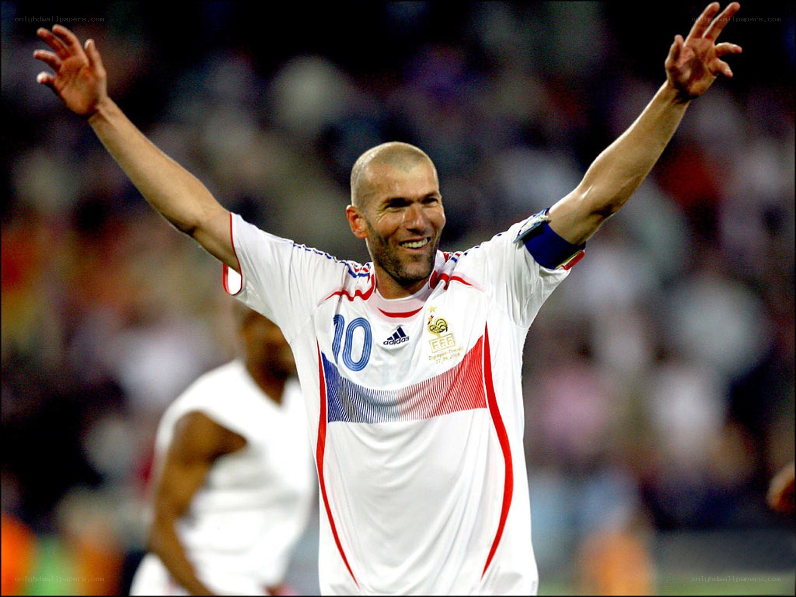 Zidane celebrates with arms raised