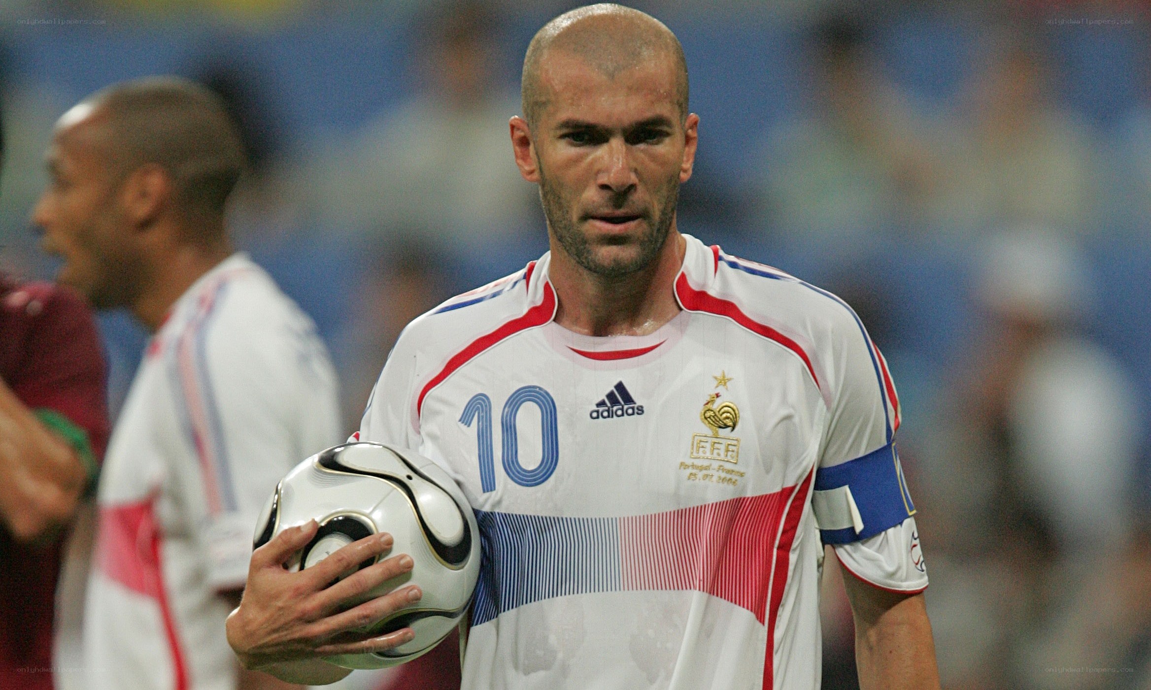 Zidane holding a soccer ball