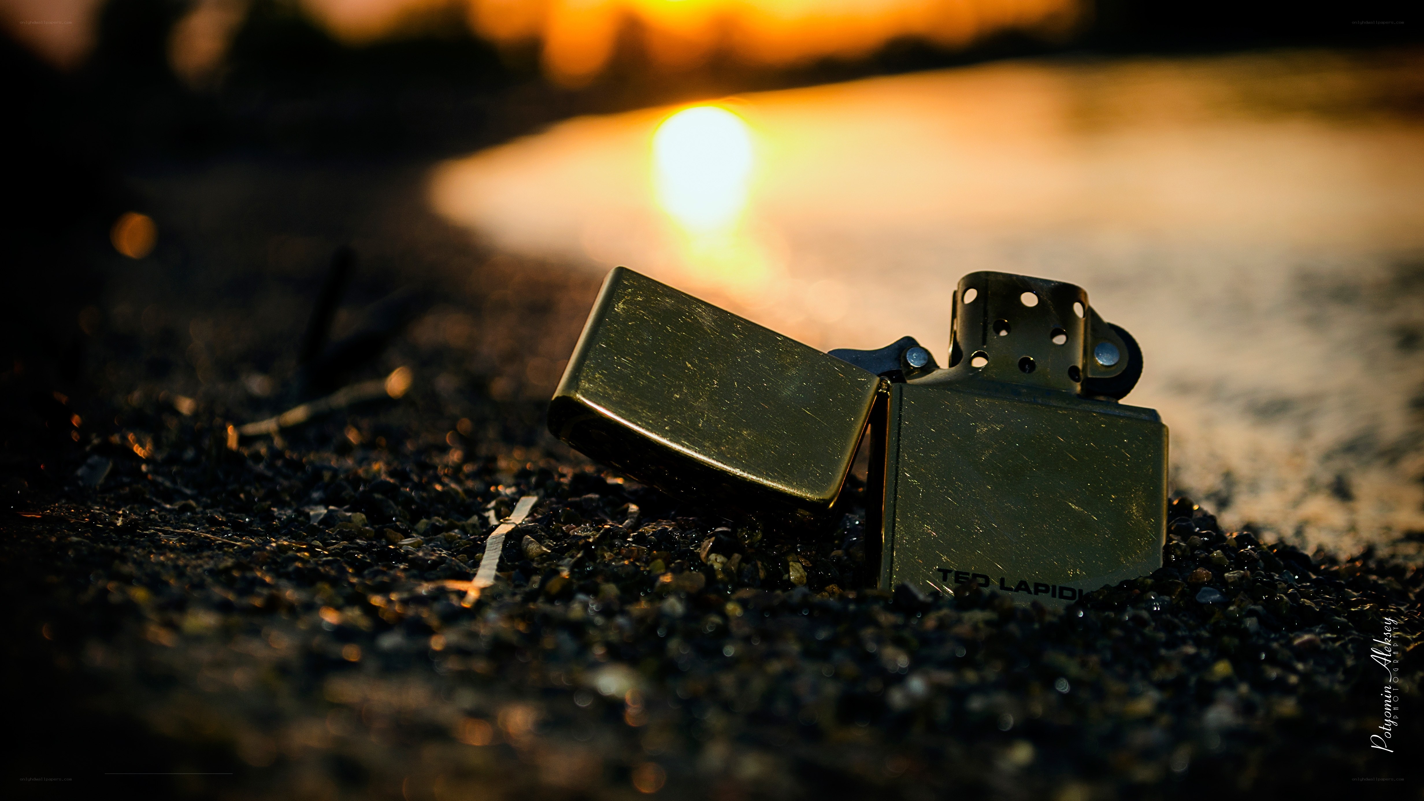 Zippo lighter on beach at sunset